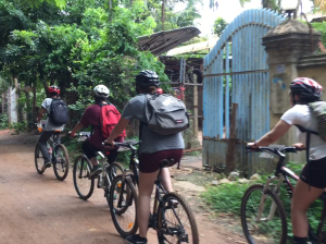 a group of cyclists riding through Battambang 